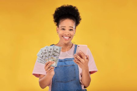Photo for Phone, money and winner with portrait of black woman in studio for success, prize or online payment. Bonus, lottery and fintech with person and cash on yellow background for dollar, sale or giveaway. - Royalty Free Image