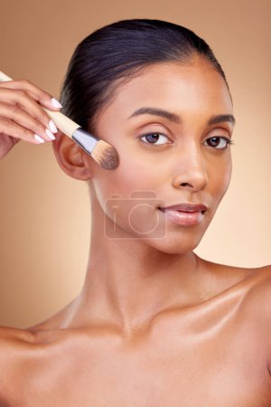 Photo for Foundation, makeup and brush with portrait of woman in studio for facial, beauty and self care. Cosmetics, product and tools with face of model on brown background for glow, skincare and dermatology. - Royalty Free Image