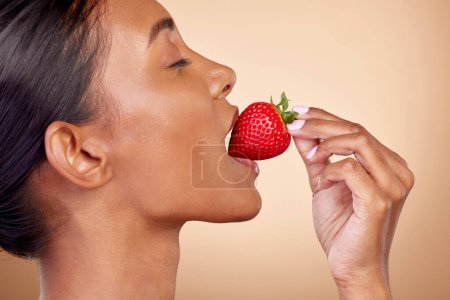 Photo for Eating, strawberry and profile of woman for skincare with natural beauty or benefits from healthy nutrition, diet and fruit. Girl, bite of food and vitamin c for skin to glow, shine or wellness. - Royalty Free Image