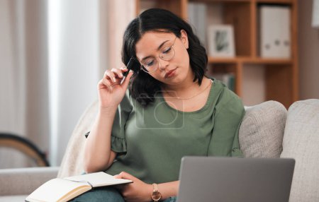 Photo for Woman, student and laptop, notebook and thinking or studying and planning schedule for work from home. Person with journal ideas for online education, e learning and knowledge on sofa and computer. - Royalty Free Image