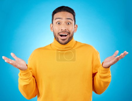 Photo for Wow, portrait and asian man in studio with hands for choice, decision or questions on blue background. Palm, scale and face of male customer confused, asking or why emoji for choosing, option or deal. - Royalty Free Image