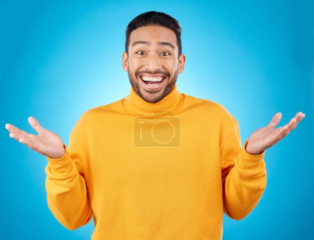 Photo for Wow, portrait and happy man in studio with hands for choice, decision or questions on blue background. Palm, scale and face of male customer excited, asking or why emoji for choosing, option or deal. - Royalty Free Image