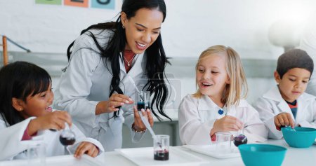 Photo for Science, education and children in a classroom with their teacher for learning or to study chemistry. Kids, school and scholarship with students in lab class for an experiment of chemical reaction. - Royalty Free Image