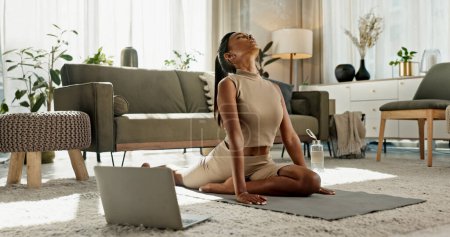 Photo for Home, yoga and woman stretching on the floor in living room with online class in apartment. House, exercise and girl workout with webinar on computer for zen mindfulness, wellness and mental health. - Royalty Free Image