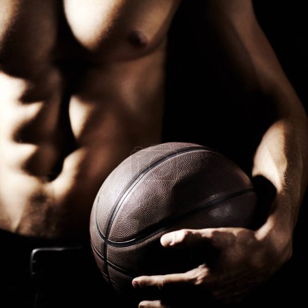 Photo for Muscle, body and hands of athlete with basketball in studio isolated on a black background. Sports, closeup and strong man with ball, abs and workout for fitness, training or exercise for health. - Royalty Free Image