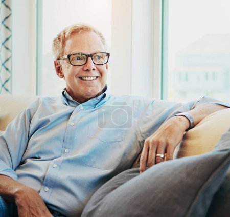 Photo for Thinking, senior man and relax on the sofa of home in the morning during retirement break. Smile, calm and an elderly person on the iving room sofa for a happy, idea or enjoying free time on weekend. - Royalty Free Image