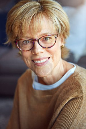 Photo for Portrait, glasses or happy mature woman in house living room to relax with freedom on sofa for resting break. Apartment, face or senior person with smile or wellness in retirement, lounge or home. - Royalty Free Image