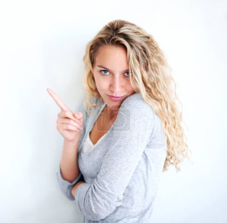 Photo for Woman, portrait and pointing finger playful or flirt fun, white wall background as mockup space. Female person, confident and goofy face emoji hand gesture or showing attention, joke humor in Canada. - Royalty Free Image