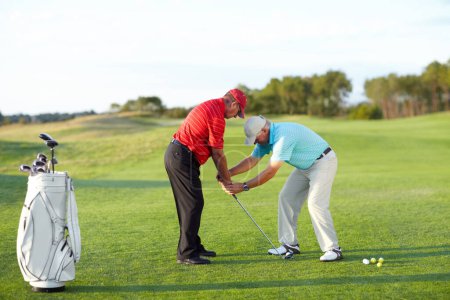 Photo for Golf training, help and men with a game on a field for a competition, showing or support. Fitness, exercise and friends or people on a course for sports advice, assistance and at a professional club. - Royalty Free Image