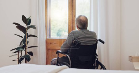 Photo for Wheelchair, thinking and senior man back in retirement home with mental health and grief. Bedroom, sad and elderly male person with disability at window with memory, lonely and dream in a house. - Royalty Free Image