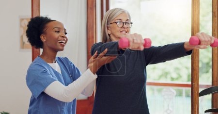 Photo for Physical therapy, exercise and senior woman with dumbbell, weightlifting and training arms and muscle. Strong, fitness and old person with nurse or physiotherapist to help in rehabilitation workout. - Royalty Free Image