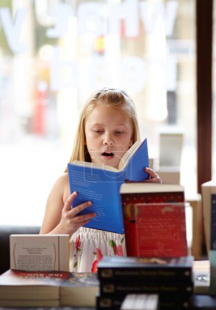 Photo for Shock, stack of books and child in bookshop, learning and studying, homework and knowledge in store. School, surprise face and girl in bookstore with story, fantasy and education in shop reading - Royalty Free Image