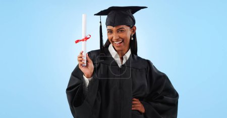Photo for Graduate woman, certificate and portrait in studio with pride, success and achievement by blue background. Graduation, girl and diploma with award, celebration or paperwork for future from university. - Royalty Free Image