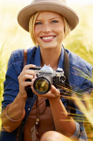 Photo for Outdoor, photographer and woman with a camera, portrait and smile with nature, travel and memory with sunshine. Person, countryside or face with photography, field and journey with picture or summer. - Royalty Free Image