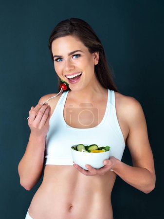 Photo for Salad, woman eating and portrait with fitness, health and nutrition of meal with smile in studio. Workout, happy and female model with exercise and training with healthy food and vegetables for diet. - Royalty Free Image