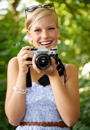 Photo for Portrait, camera lens and photographer with woman in forest for smile, memory and photography. Summer, happy and adventure with person and shooting for vacation, holiday and environmental tourism. - Royalty Free Image