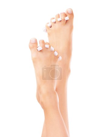 Photo for Beauty, pedicure and feet of person on a white background for grooming, spa treatment and wellness. Luxury, salon and isolated toes with separator for nail polish, cosmetics and aesthetic in studio. - Royalty Free Image