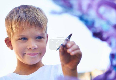 Photo for Boy, thinking and painting with creativity, artistic and development with colour, happy and ideas. Person, student and kid with a childhood, artwork and fantasy with brainstorming and school project. - Royalty Free Image