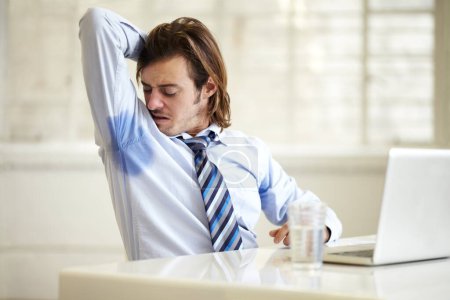 Photo for Businessman, armpit and sweat smell at work for company employee stress, stink hygiene or bad stain. Male person, laptop and arm up for cleanliness mistake fail or frustrated, or wet shirt in office. - Royalty Free Image