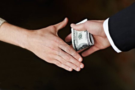 Photo for Hands, bribe and cash for payment, deal with handshake, corruption and crime opportunity with dark background. People, businessman or corporate scam with money laundering and professional fraud. - Royalty Free Image