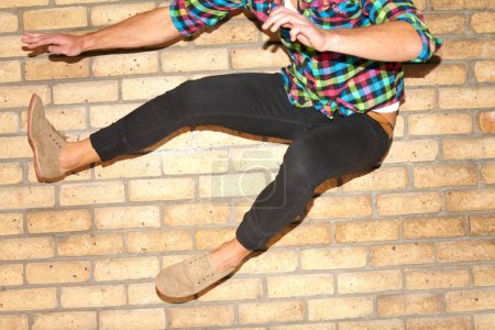 Photo for Fun, air and legs of a person on a wall for jumping, dance or action in the city. Energy, shoes and a man with speed, crazy activity and movement for urban culture, playful and enjoying weekend. - Royalty Free Image