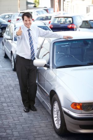 Photo for Portrait, thumbs up and a man at the dealership for a car sale, lease or rental in a commercial parking lot. Smile, retail or agreement with a happy young salesman working in the vehicle trade. - Royalty Free Image