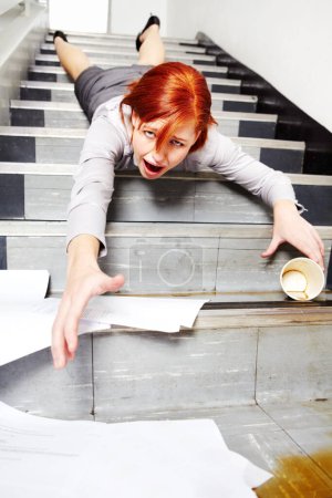 Photo for Woman, falling down and stairs for injury, accident and wow with coffee, documents or paperwork in building. Business, person or employee slipping on steps at work or office with paper, cup and shock. - Royalty Free Image