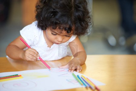 Photo for Young, girl or drawing at table in classroom for creative development, education growth in kindergarten. Child, daycare or pencils artwork for learning play in school or paper crayons, craft or color. - Royalty Free Image