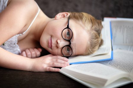 Photo for Portrait, learning and a child reading a book for knowledge, studying or to relax on the floor. Library, young and a girl, kid or a student at school with a novel, story or getting ready for an exam. - Royalty Free Image
