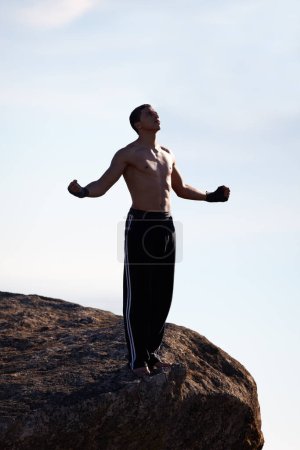 Photo for Mountain top, fitness man and freedom with winner fist in nature for training, wellness or sports on sky background. Exercise, success and male athlete with cardio, gratitude or workout celebration. - Royalty Free Image