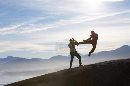 Photo for Mountain top, karate men and jump, kick or fitness training in nature for body, speed or power on sky background. Martial arts, taekwondo or MMA friends workout outdoor for cardio, exercise or sports. - Royalty Free Image