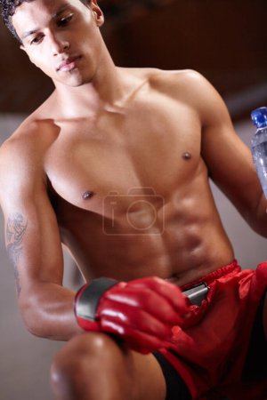 Photo for Boxing, man and thinking of workout or fight in the ring for a match or training in gym. Health, fitness and strong fighter exercise for sports or rest break in rounds of fighting competition. - Royalty Free Image