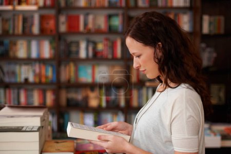 Photo for Woman, bookstore and reading with sale, choice and thinking for decision, learning or ideas. Girl, novel or literature in store, library or college for deal, discount or retail shopping for knowledge. - Royalty Free Image