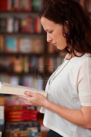 Photo for Woman, bookstore and reading with shopping, choice and thinking in profile, learning and idea. Girl, novel or literature in store, library or college for school, discount or retail sale for knowledge. - Royalty Free Image