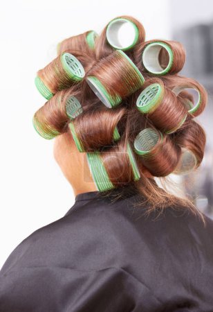 Photo for Hair care, woman in salon with curlers for beauty and luxury hairstyle at professional service from back. Haircare, rollers and girl at hairdresser with tools for wellness, color and style at spa - Royalty Free Image