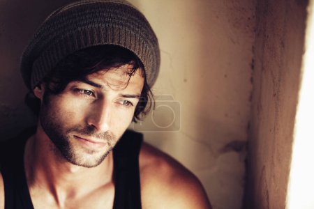 Photo for Fashion, thinking and man relax on travel, vacation or solo trip holiday at a hotel room window. Street wear, traveling and calm male person enjoy a peaceful moment indoors with freedom or chilling. - Royalty Free Image