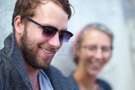 Photo for Man, smile and fashion or sunglasses outdoors, trendy and urban or happy for style. Male person, outside and wall or accessory, cool and confident by backdrop, modern hipster and joy in downtown. - Royalty Free Image