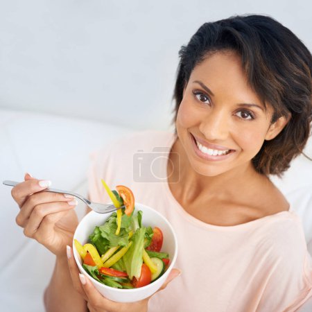 Photo for Lunch, salad and portrait of happy woman eating for nutrition, health and wellness in diet. Healthy food, fruit and vegetables in bowl for meal on sofa in home living room with happiness and a smile. - Royalty Free Image