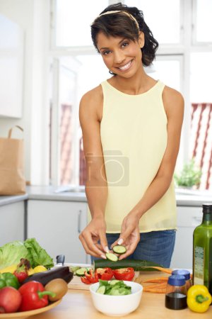 Photo for Portrait, salad and woman with vegetables, kitchen and smile with wellness, home and cooking. Person, happy and girl with healthy food, nutrition and fresh with meal, apartment and hungry with vegan. - Royalty Free Image