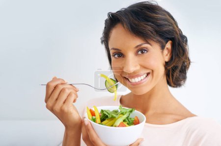Photo for Happy woman, portrait and vegan with salad bowl for diet, snack or natural nutrition against a studio background. Face of female person smile eating organic food for fiber, vitamins or healthy meal. - Royalty Free Image