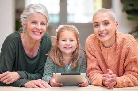 Photo for Little girls rule the world. Portrait of a mature woman bonding with her daughter and granddaughter while using a digital tablet - Royalty Free Image