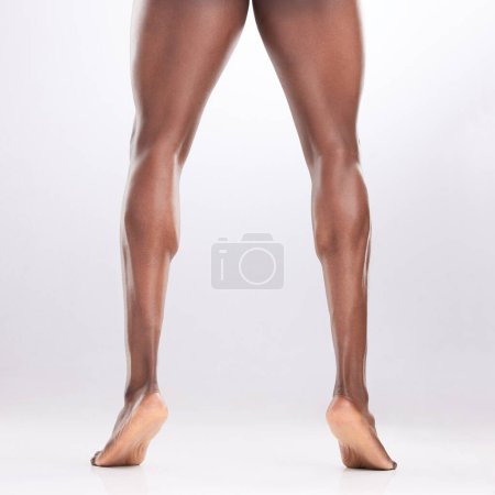 Photo for Toned legs are underrated. an unrecognizable man showing off his muscular legs while posing against a white background - Royalty Free Image