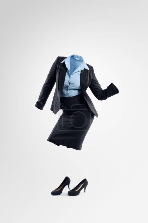 Photo for Dance like no ones watching. Studio shot of an invisible businesswoman dancing against a grey background - Royalty Free Image