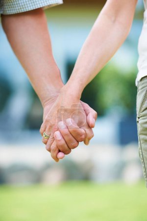 Photo for Couple, love or holding hands for support in park, nature or outdoors on a romantic walk in summer. Wellness, romance or closeup of man with woman bonding, affection or enjoying date together outside. - Royalty Free Image