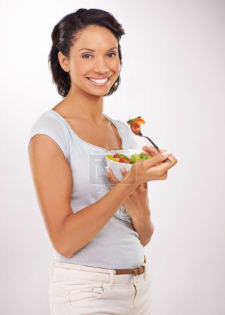 Téléchargez les photos : Femme heureuse, portrait et salade pour la diète de fruits, collation ou nutrition naturelle sur fond de studio. Femme sourire avec bol d'aliments biologiques pour fibres, vitamines ou repas sains dans le bien-être. - en image libre de droit