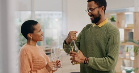Photo for African couple, glasses and champagne in home with smile, celebration and party for success in living room. Black woman, man and bottle of sparkling wine for achievement, goals and drink in house. - Royalty Free Image
