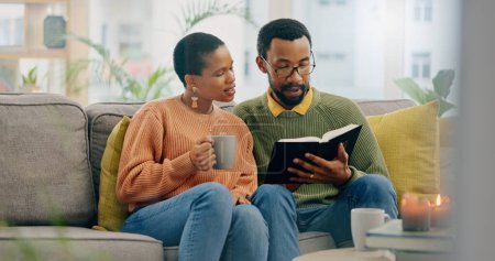 Photo for Home, relax and black couple on a couch, bible and reading with religion, love and bonding together. Romance, apartment or man with woman, scripture and holy book with Christian, hope or conversation. - Royalty Free Image