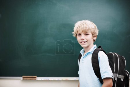 Photo for Hes open to so many new ideas. Portrait of a smiling young boy standing alongside copyspace at a blackboard - Royalty Free Image