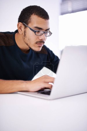Photo for Working hard on a brand new design. a handsome young man working on his laptop in an office - Royalty Free Image