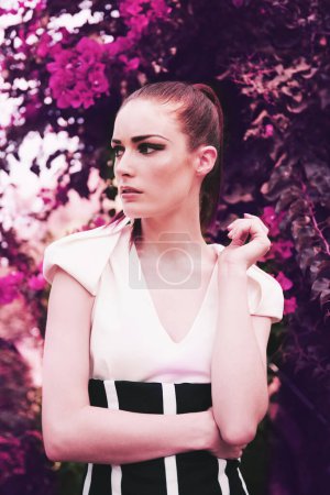 Photo for Her beauty is blossoming. an attracttive and fashionable young woman posing in the midst of nature - Royalty Free Image